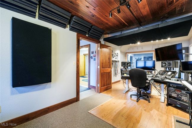 Office space with track lighting, wood ceiling, light wood-style floors, and baseboards | Image 6