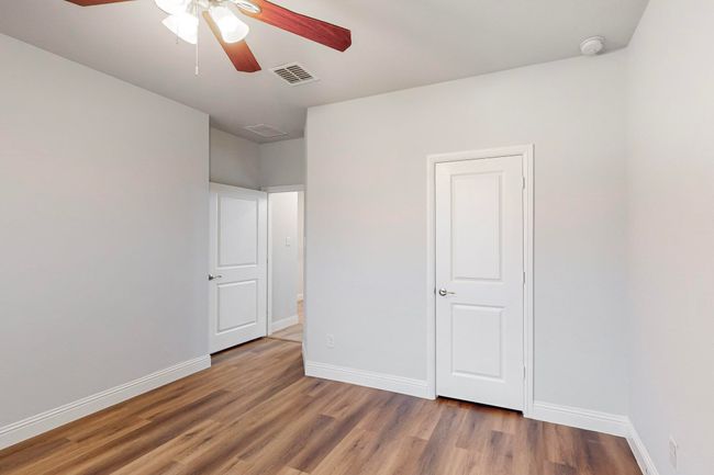 Empty room featuring ceiling fan and wood-type flooring | Image 16