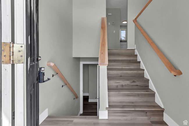 Stairway featuring wood finished floors | Image 6