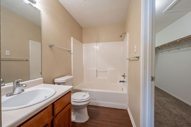 Full bathroom with toilet, vanity, shower / bathtub combination, and wood finished floors | Image 18