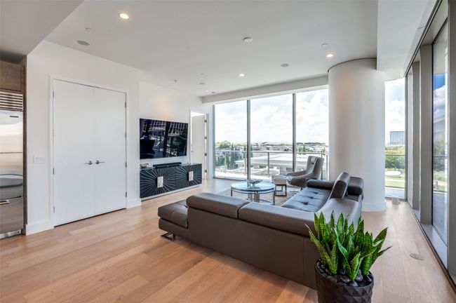 Living area with light wood finished floors and recessed lighting | Image 15