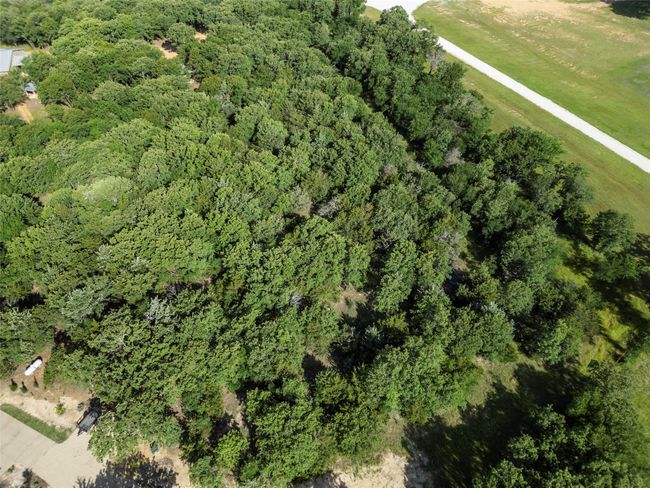 Aerial view of property and surrounding area with a heavily wooded area | Image 7