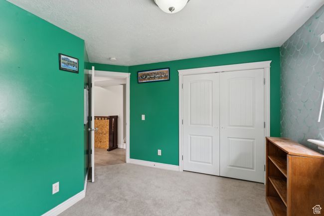 Unfurnished bedroom featuring a closet, carpet floors, and baseboards | Image 31