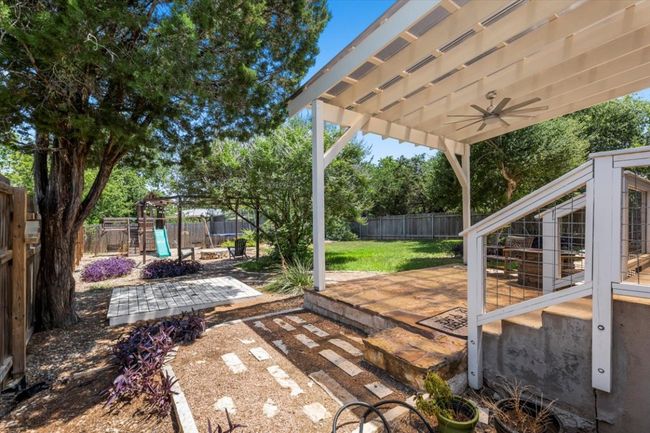 View of yard with a playground, ceiling fan, and a patio | Image 32