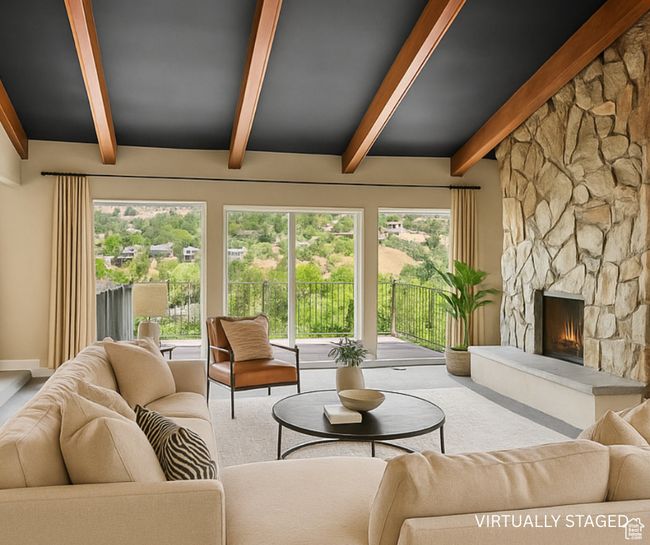 Living room featuring beam ceiling, a fireplace, and carpet flooring | Image 11