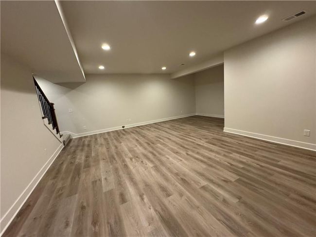 Finished below grade area featuring recessed lighting, wood finished floors, and stairs | Image 61