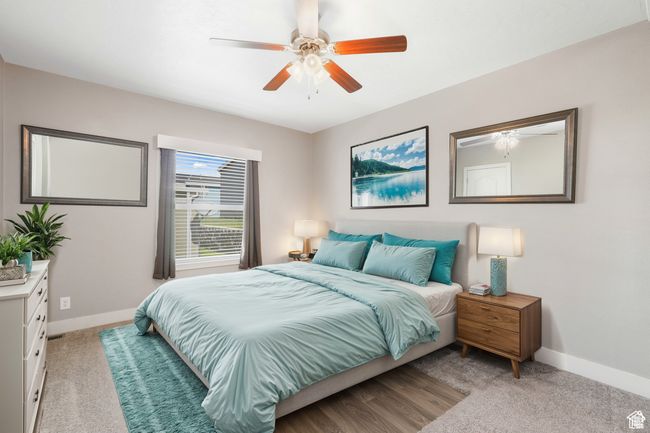 Bedroom featuring baseboards, a ceiling fan, and light colored carpet | Image 11
