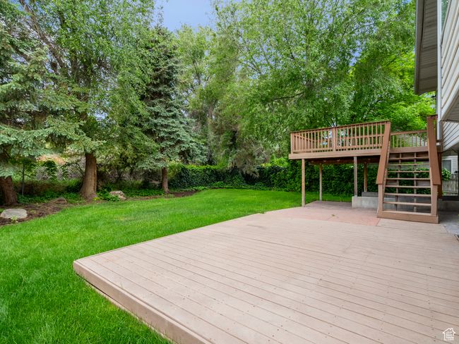 Wooden terrace with stairs and a yard | Image 6