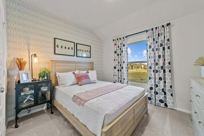 Bedroom with light carpet, vaulted ceiling, baseboards, and wallpapered walls | Image 7