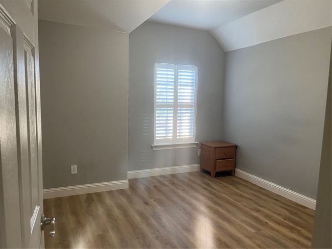 Empty room featuring wood finished floors and lofted ceiling | Image 12