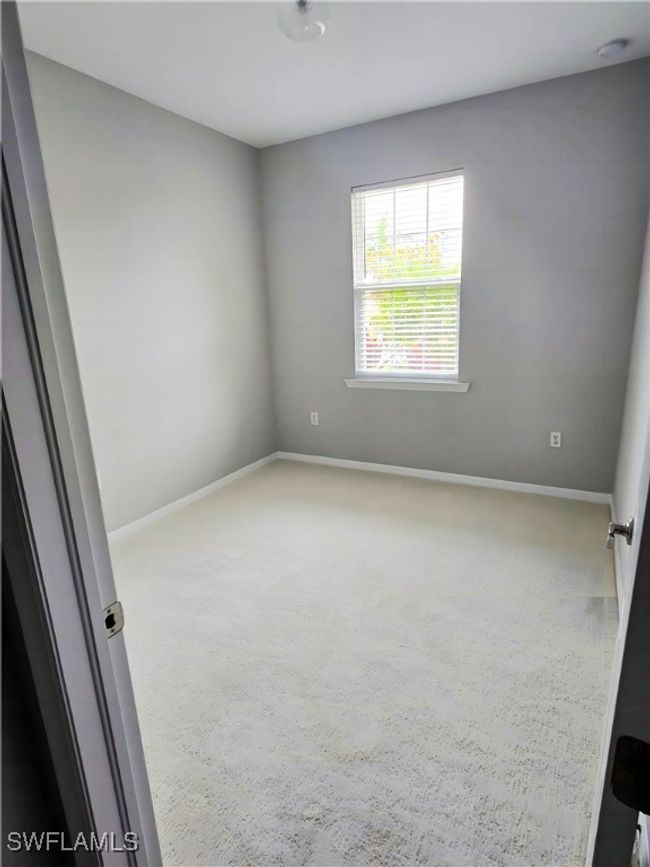 Carpeted spare room with baseboards and a smoke detector | Image 4