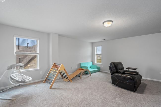 Living area with carpet, plenty of natural light, baseboards, and a textured ceiling | Image 20