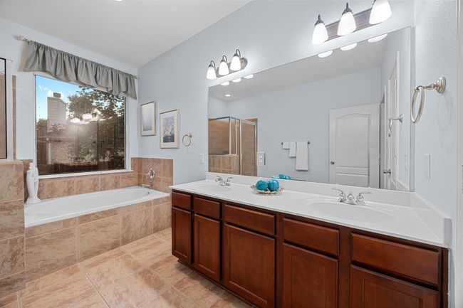 The primary bathroom has a double vanity, large soaking tub, and separate walk-in shower. | Image 8