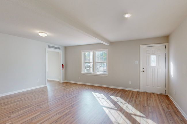 Foyer featuring beam ceiling and light wood-type flooring | Image 7