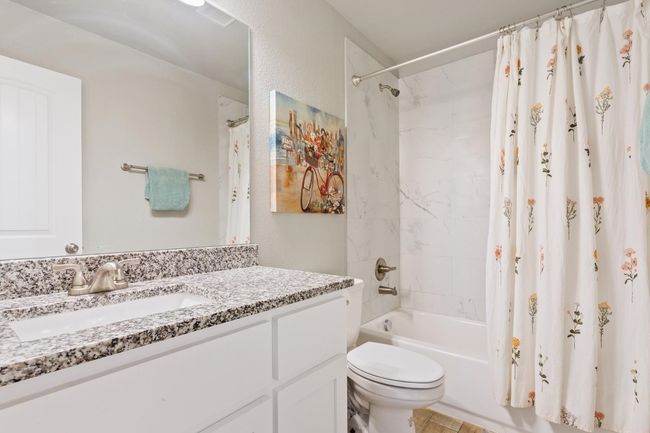 Bathroom with vanity and shower / bathtub combination with curtain | Image 23