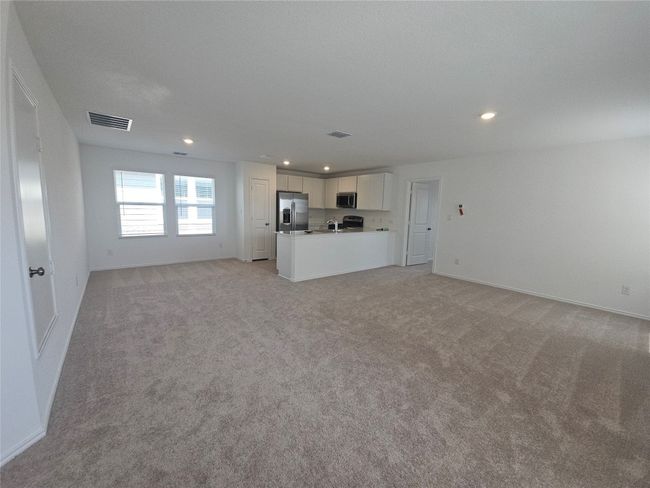 Unfurnished living room with light colored carpet, recessed lighting, and baseboards | Image 16