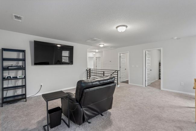 Living area with carpet, baseboards, and a textured ceiling | Image 21