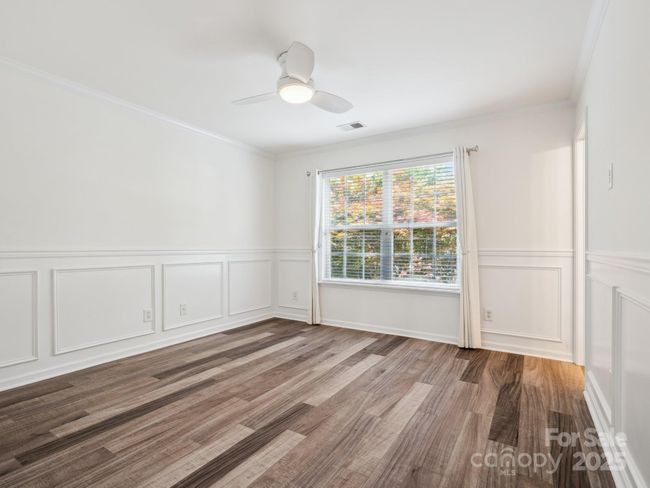 Primary Bedroom is on the second floor. It has luxury Vinyl flooring, new paint, wainscoting and crown molding with a nice view of the maple tree in the backyard. | Image 16