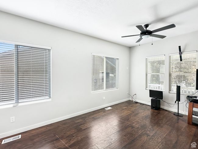 Unfurnished office with plenty of natural light, ceiling fan, and dark wood-type flooring | Image 4