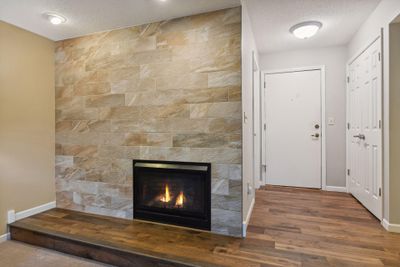 Gas Burning Fireplace and Foyer with front closet and convenient storage room. | Image 3