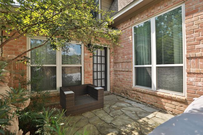 Private patio off the primary bedroom offers a tranquil outdoor retreat. Perfect for morning coffee or evening relaxation in your own secluded space. | Image 18