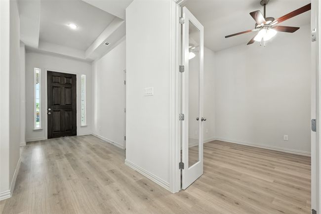 Entrance foyer with light wood-type flooring, a ceiling fan, a raised ceiling, and recessed lighting | Image 26