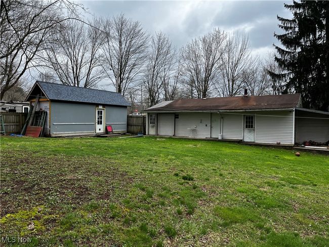 Rear view of house with fence and a lawn | Image 18