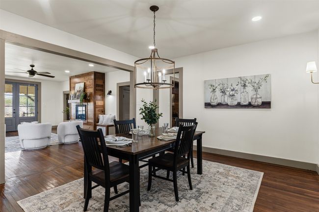 Dining space with a chandelier, dark wood-style flooring, recessed lighting, ceiling fan, and baseboards | Image 14