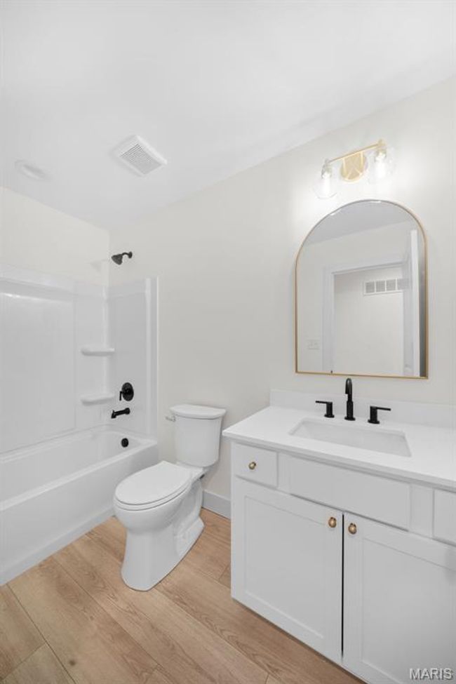 Full bathroom featuring vanity, wood finished floors, and tub / shower combination | Image 32