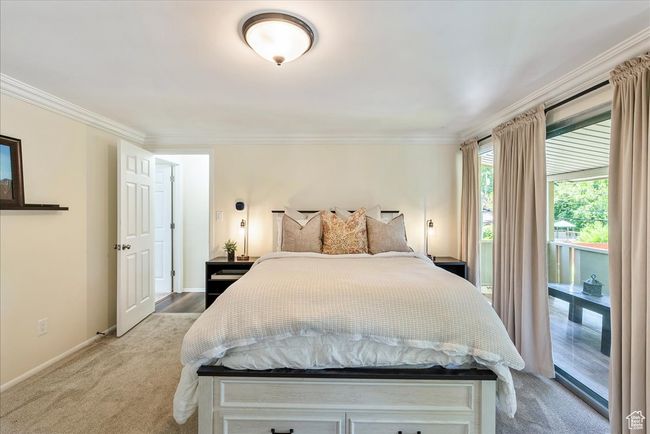 Bedroom with ornamental molding, light colored carpet, and access to exterior | Image 34