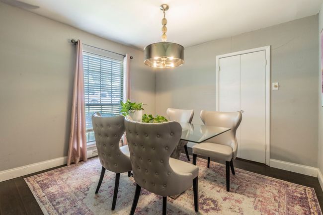 Dining area featuring baseboards, wood finished floors, and a chandelier | Image 10