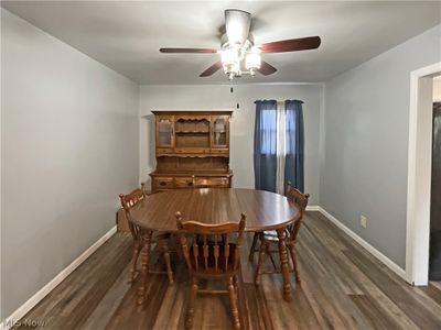 Dining area with ceiling fan and dark wood-type flooring | Image 3