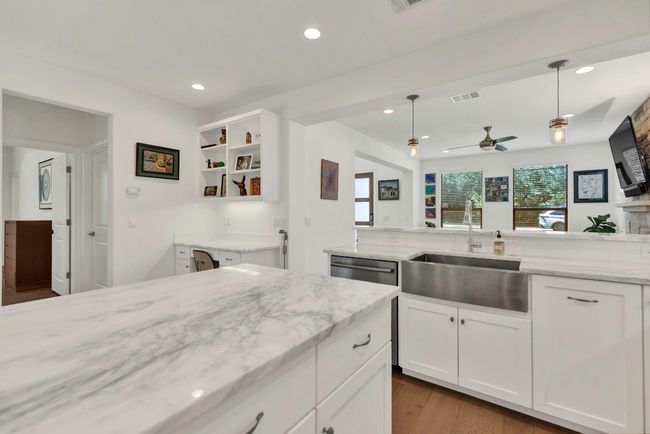 Kitchen featuring recessed lighting, light stone counters, white cabinets, open shelves, and ceiling fan | Image 8