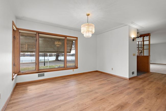 Main Floor Formal Dining Room with lots of windows to capture the Lake and Sunset views! | Image 49