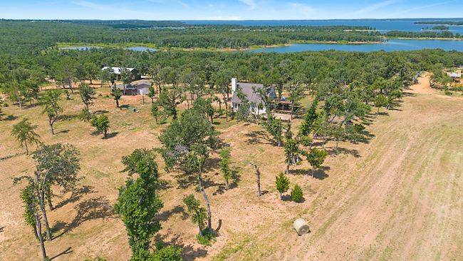 Aerial view of a nearby body of water and a heavily wooded area | Image 7