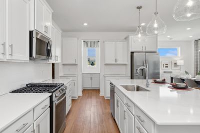 (*Photo of decorated model, actual homes colors and finishes will vary) Stunning cabinets help bring this home's kitchen to life. | Image 2