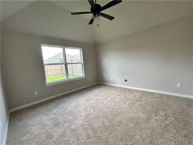 Carpeted empty room with lofted ceiling | Image 8