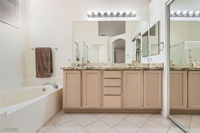 Full bath with a stall shower, tile patterned flooring, double vanity, and a garden tub | Image 28