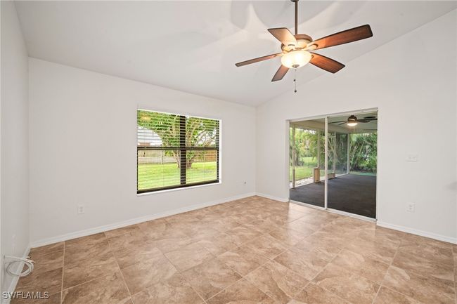 Empty room with vaulted ceiling and a ceiling fan | Image 23
