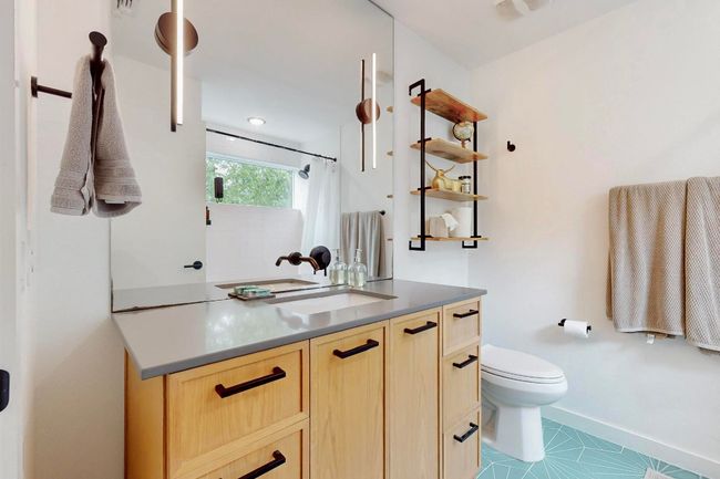 Full bath featuring vanity, toilet, baseboards, and a shower with shower curtain | Image 23