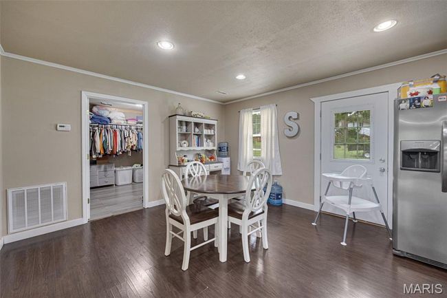Dining area featuring crown molding, recessed lighting, baseboards, dark wood-style flooring, and a textured ceiling | Image 8