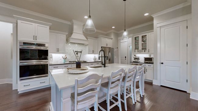 This dreamy kitchen features quartz countertops, double ovens, custom cabinets, and a large island—perfect for cooking, gathering, and entertaining in style! | Image 16