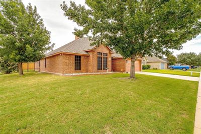 View of front of property with a garage and a front lawn | Image 1