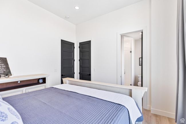 Bedroom with baseboards, recessed lighting, and light wood-style floors | Image 49