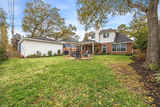 Enjoy cozy gatherings in your backyard around the inviting firepit. | Image 27