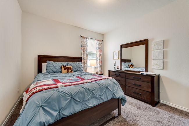 Bedroom featuring light carpet and baseboards | Image 25