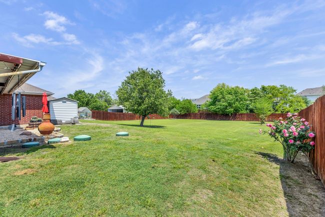 View of yard with a fenced backyard, an outbuilding, and a storage shed | Image 36