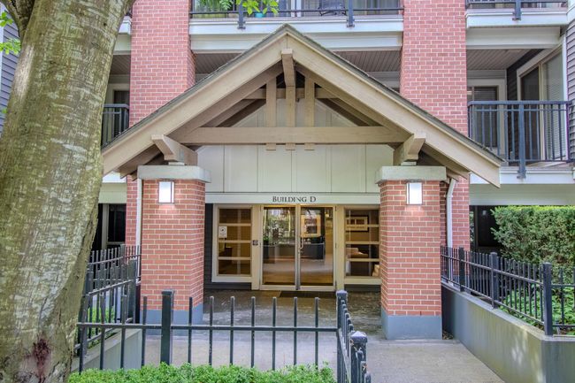 Doorway to property with board and batten siding and brick siding | Image 14