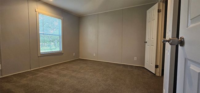 Empty room with dark colored carpet and crown molding | Image 10