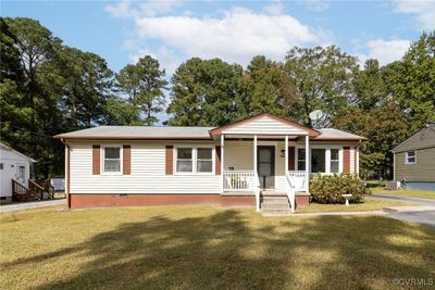 Adorable covered porch, off street parking with maintenance free siding. | Image 1